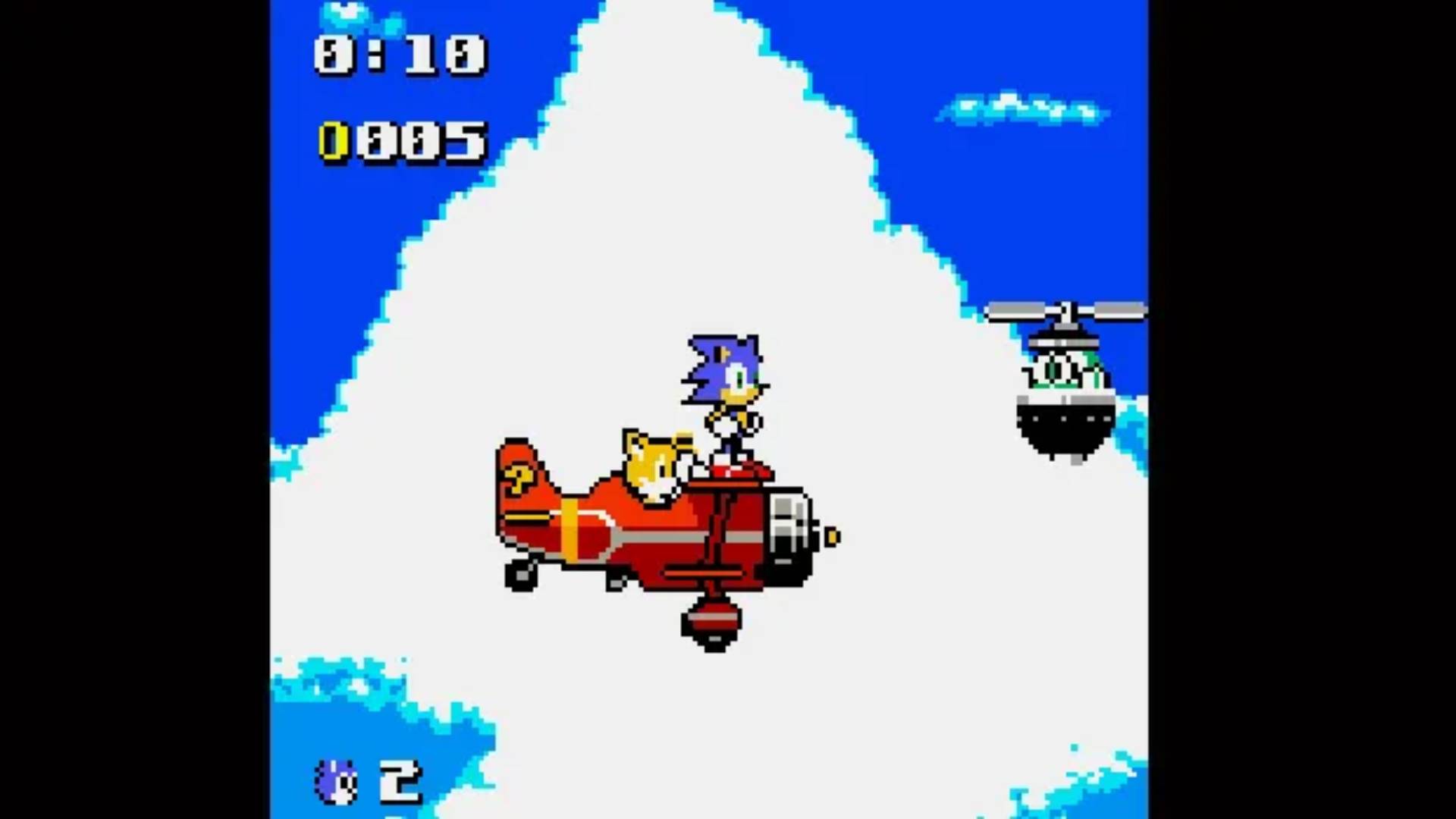 Sonic Pocket Adventure screenshot showing Sonic standing on the nose of a small plane that Tails is driving