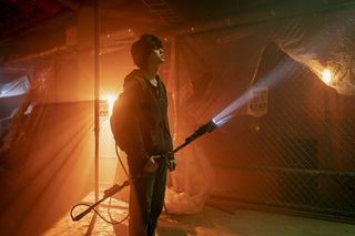 a still of Song Kang-ho, holding an electric spear with a flashlight at the end, in Netflix k-drama 'Sweet Home'