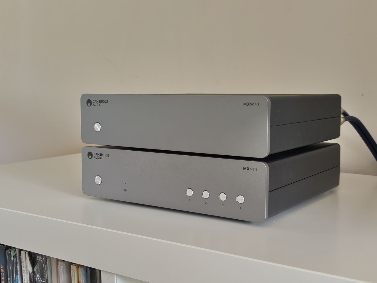 Cambridge Audio MXW70 power amp on book shelf with streamer