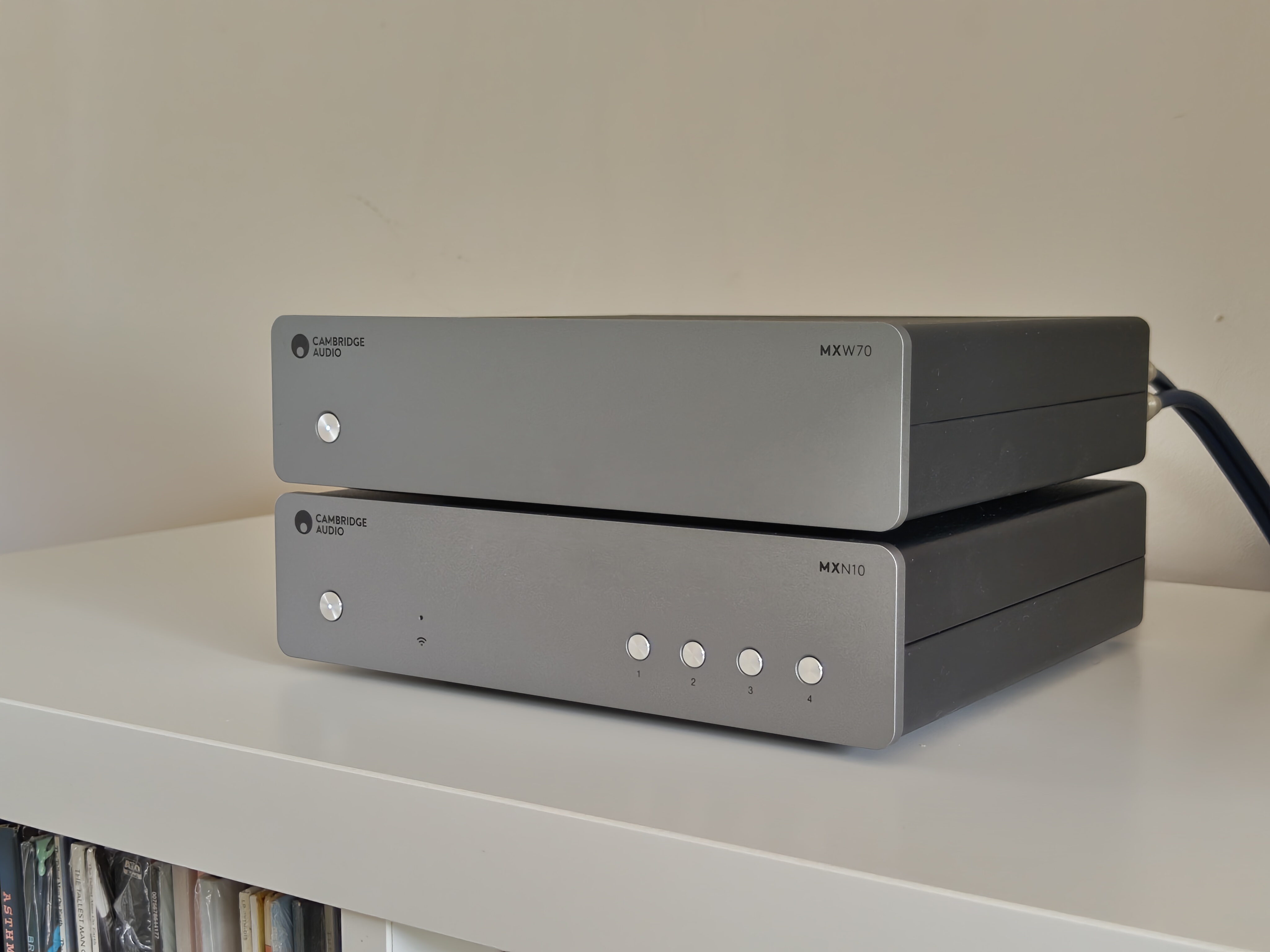Cambridge Audio MXW70 power amp on book shelf with streamer