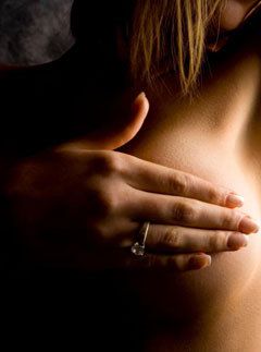 A woman examining her breasts