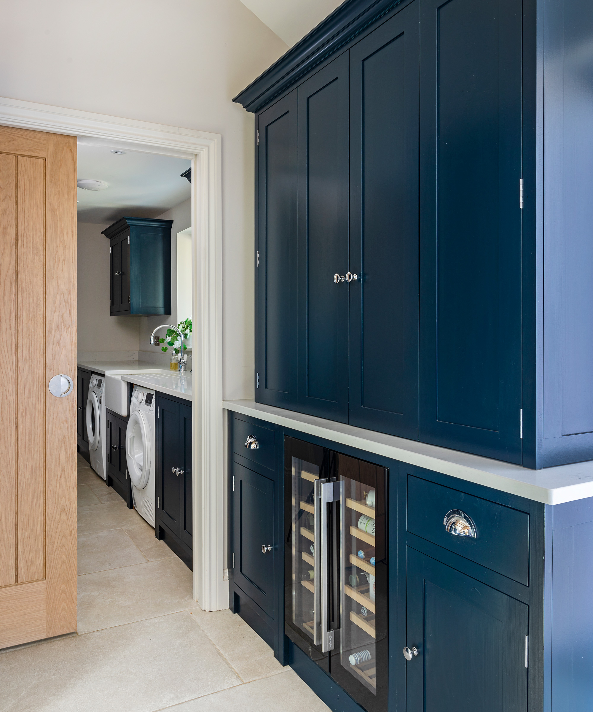 narrow blue utility room with pocket door