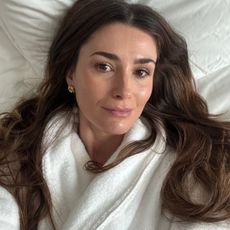 A selfie of Eleanor in a white dressing gown after using Medik8 Exo-PDRN serum