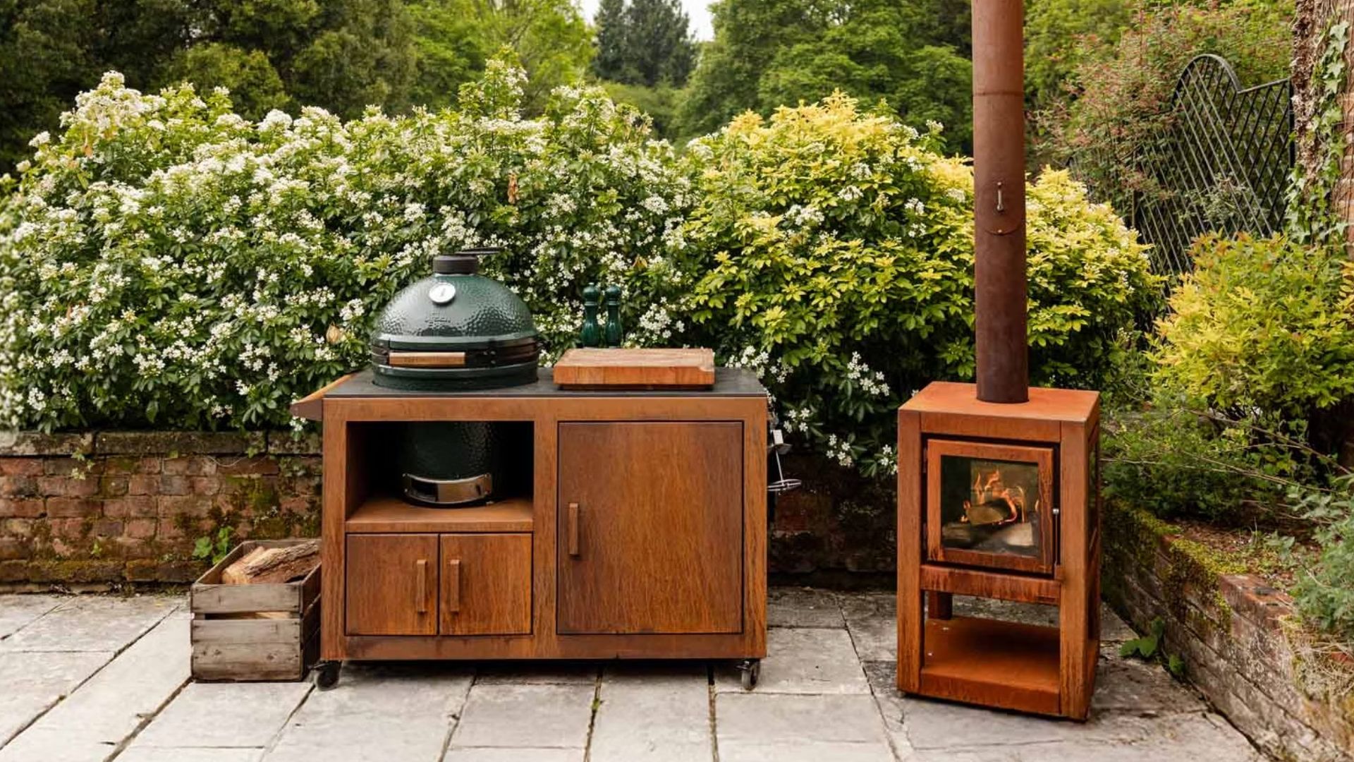 Big Green Egg next to a rusted chiminea