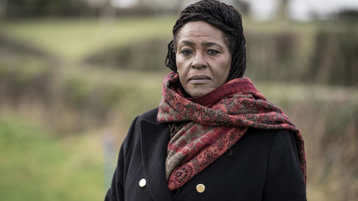 Sharon D Clarke in a black coat and red scarf as DCI Ellis in Ellis