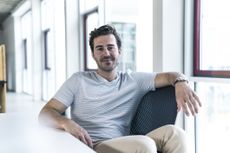 Portrait of smiling professional relaxing in modern office