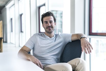 Portrait of smiling professional relaxing in modern office