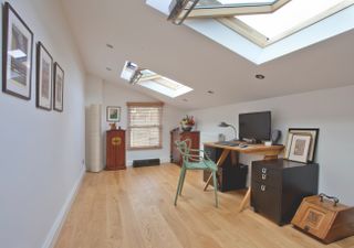 home office with vaulted ceiling and recessed spotlights