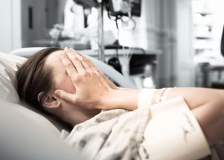 A young adult patient in a hospital bed.