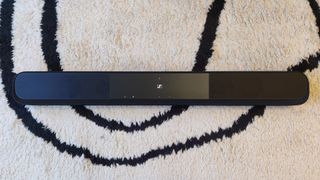 The Sennheiser Ambeo Soundbar Plus pictured from above on a black and white carpet