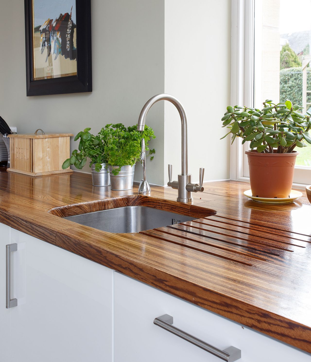 With its clean white design and lush garden backdrop, Catie Wearmouth’s kitchen is a haven for family living 