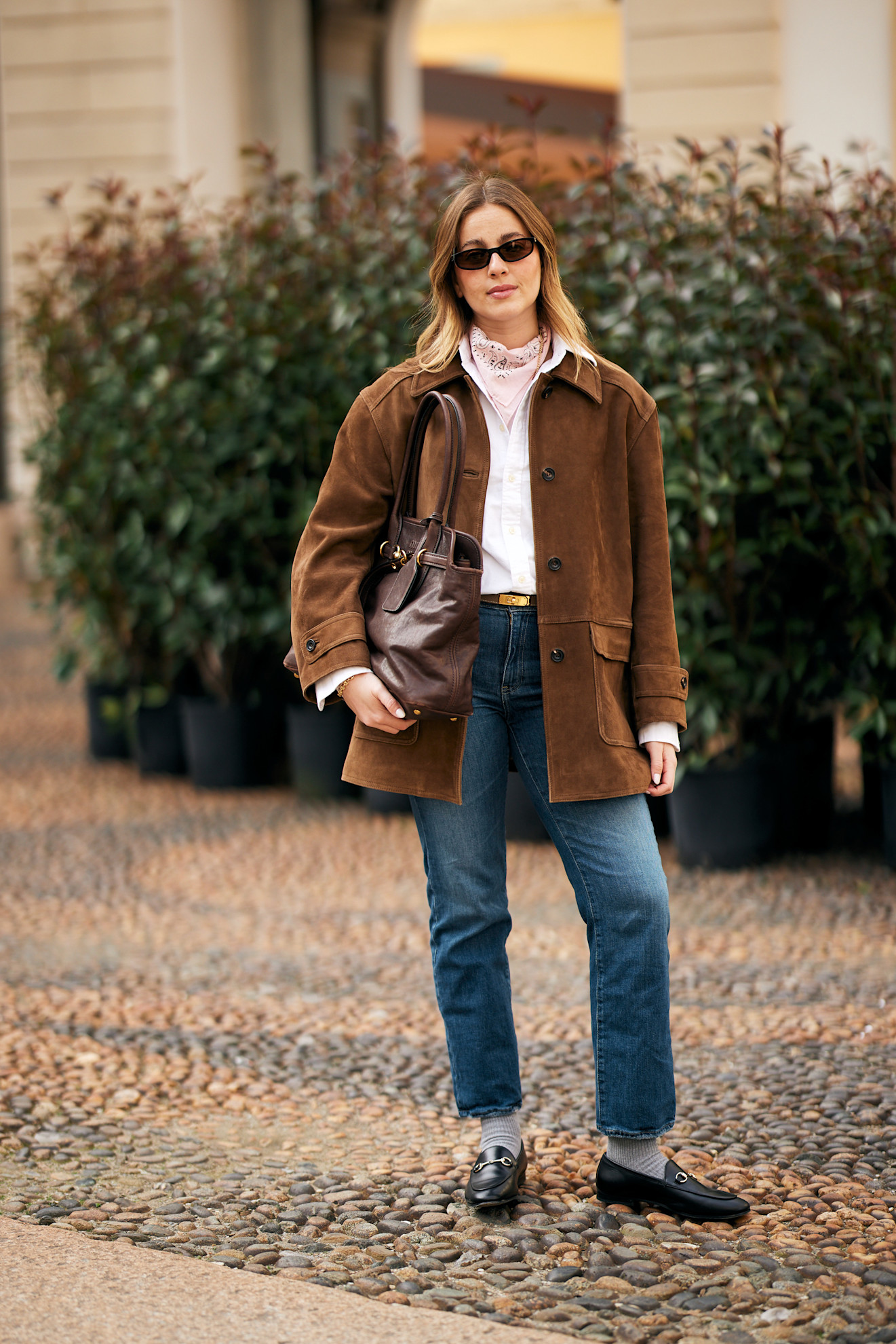 woman wearing suede jacket and stovepipe jeans