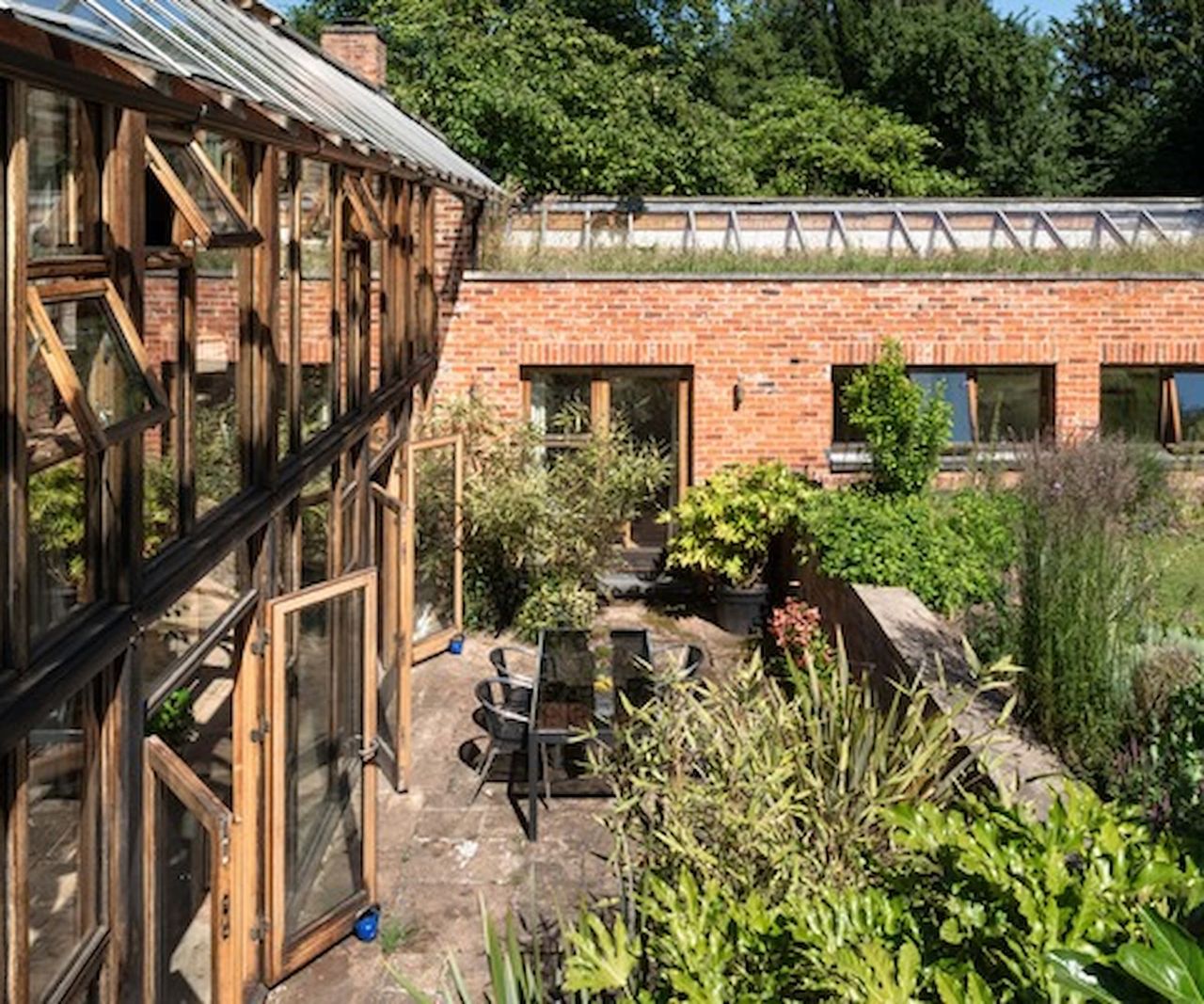 A walled garden with stone paving slabs