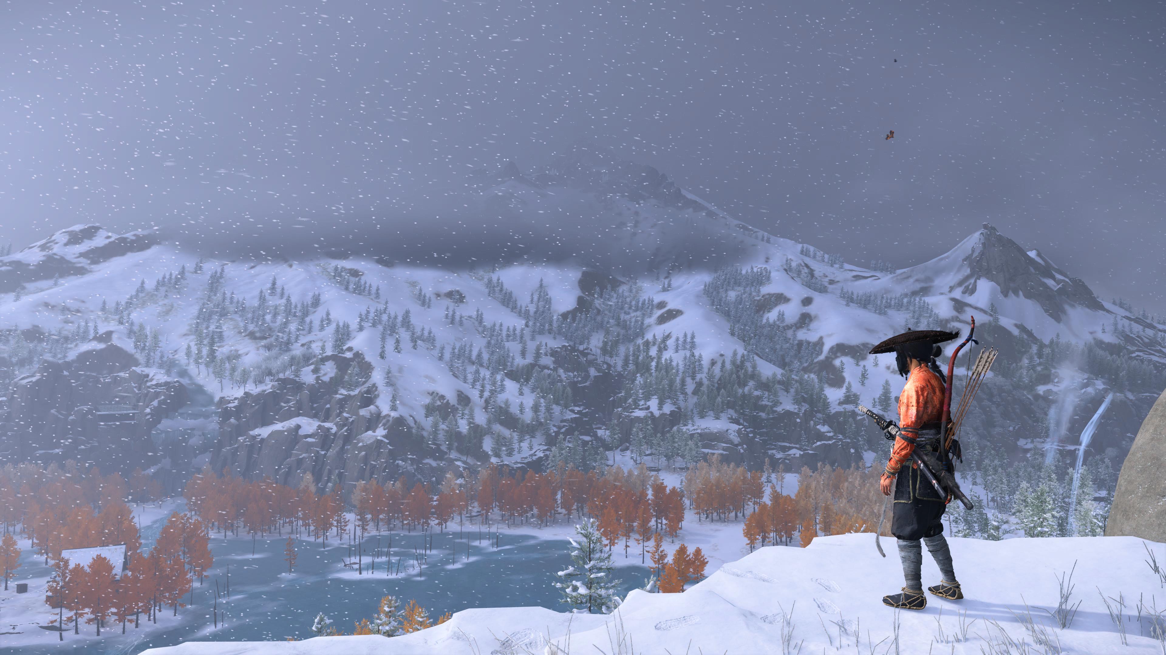 Ghost of Yotei gameplay showing Atsu stood overlooking a snowy region while wearing the Crimson Kimono
