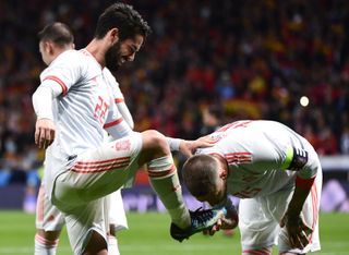 Sergio Ramos kisses the boot of Spain team-mate Isco after his goal against Argentina in a 6-1 friendly win for La Roja in March 2018.