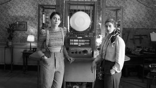 The Hanbury sisters standing in front of the LOLA machine.