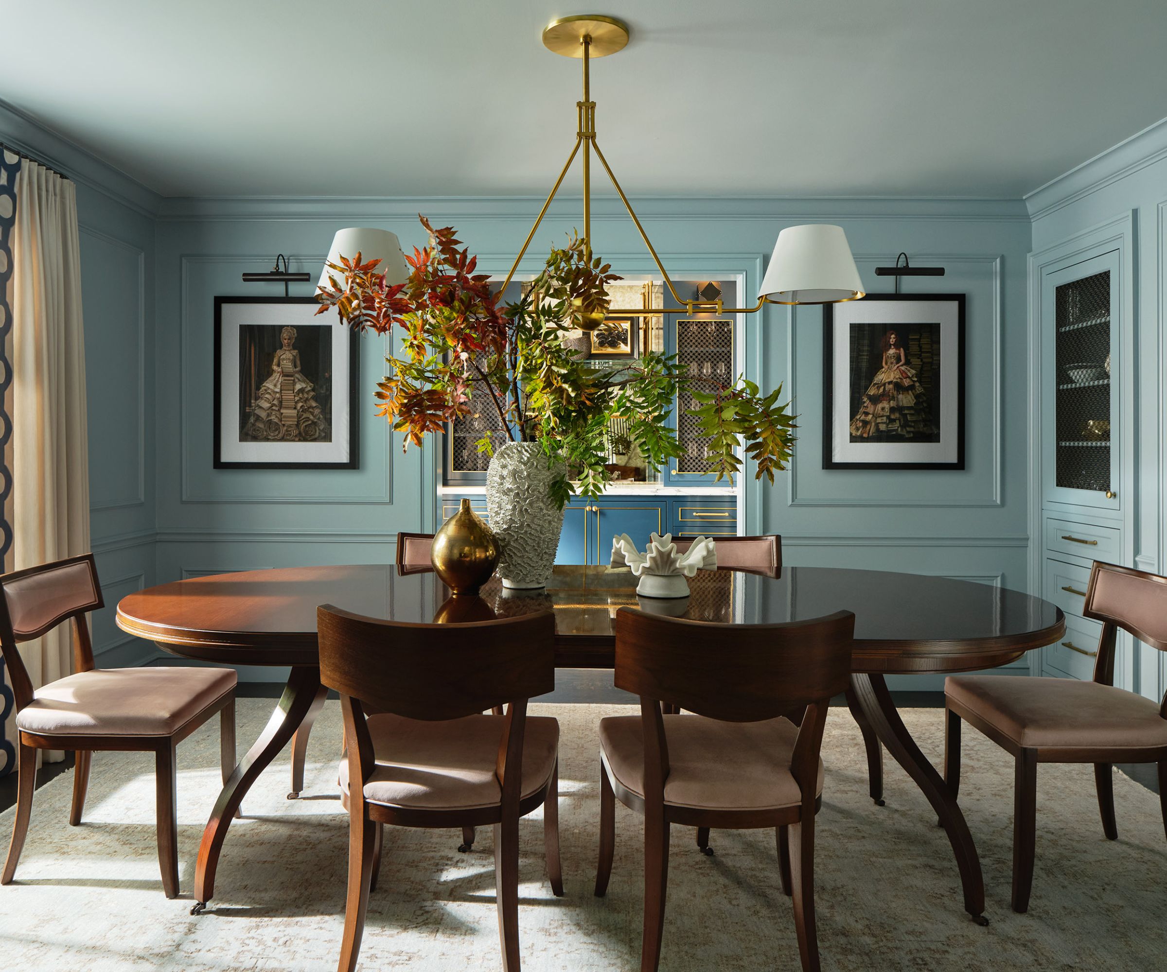 Dining room with blue walls and large dark wooden table and chairs