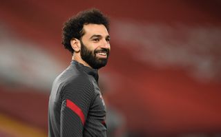 Liverpool’s Mohamed Salah warming up before the Premier League match at Anfield, Liverpool. Picture date: Thursday March 4, 2021