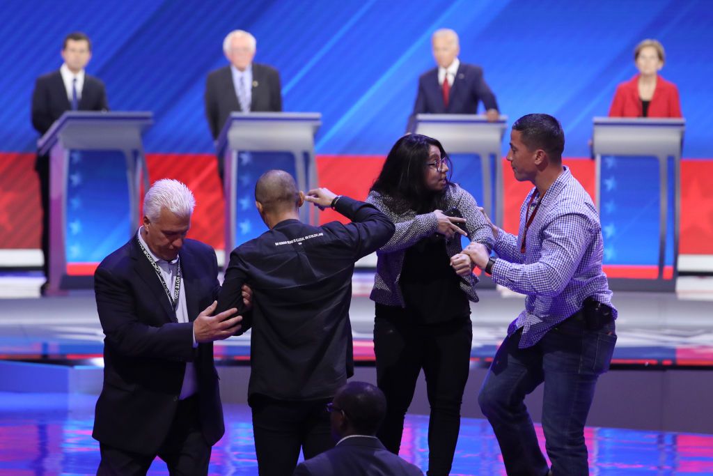 A protester at Thursday&amp;#039;s Democratic debate.