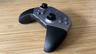 EasySMX X10 controller in gray on a wooden table
