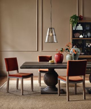 orange velvet dining chairs in a neutral dining room