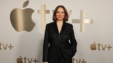 Actor Maya Rudolph stands in front of the Apple Tv+ logo. 