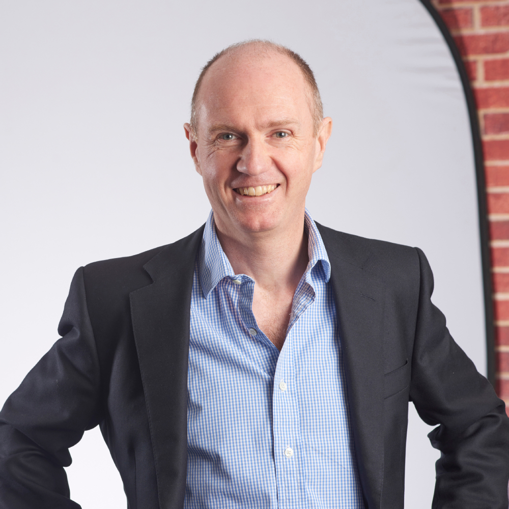 male wearing pale blue shirt and dark suit jacket