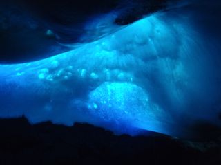 Ethereal blue light filters through Hut Cave on Mount Erebus in Antarctica in this 2010 photo.