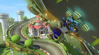 En skärmdump från Mario Kart 8 Deluxe som visar hur en spelare susar ned för en färgglad bana fylld med gröna träd och slott i bakgrunden.