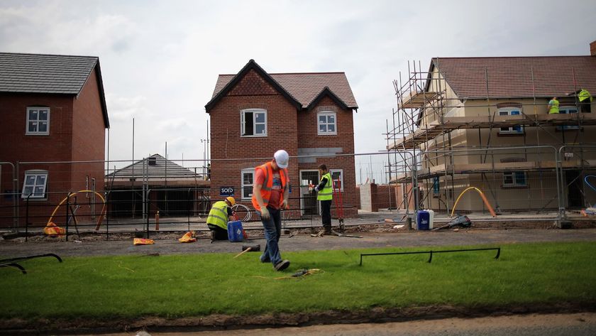Construction workers build new houses on a housing development on May 20, 2014 in Middlewich, England