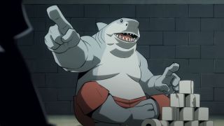 King Shark pointing and stacking toilet paper rolls on Creature Commandos