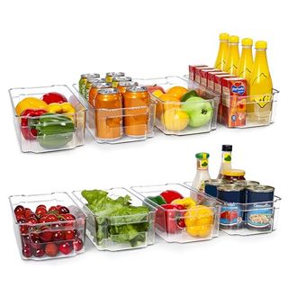 A set of eight plastic containers to organize a fridge filled with fresh food and drinks. 