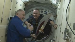 Olympic Torch Handoff on the International Space Station