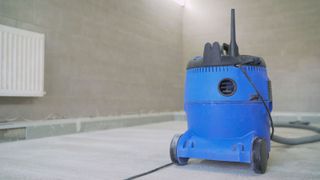 a blue builders vacuum cleaner on a building site