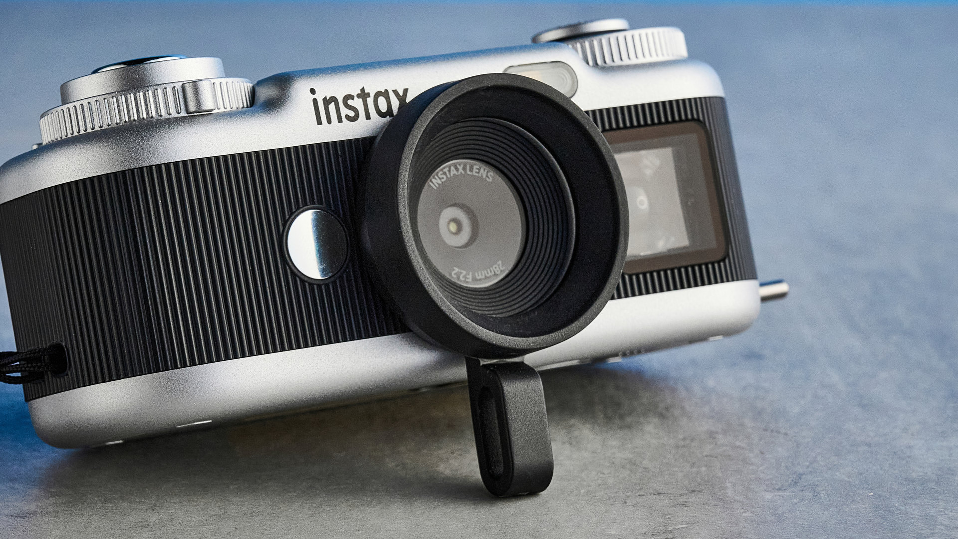 A black and silver Fujifilm Instax Pal 2 digital camera
