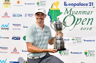 Paul Peterson holds the Myanmar Open trophy