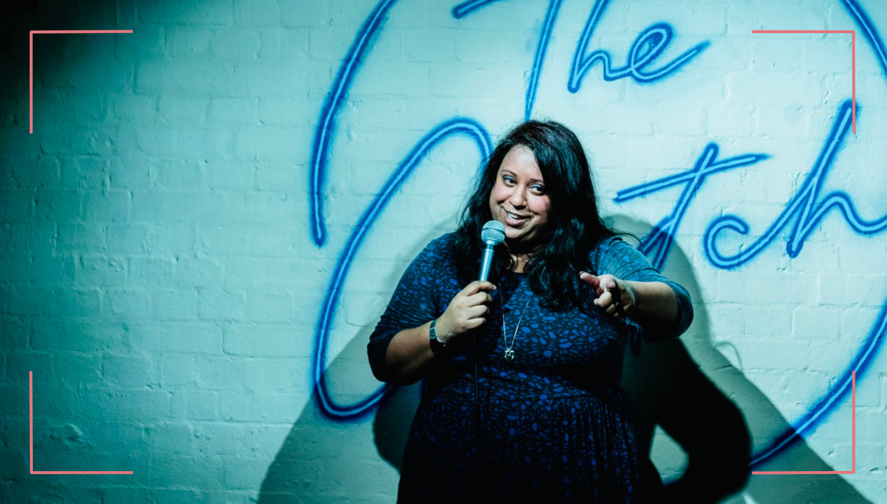 Suchandrika Chakrabarti performing on stage at a comedy club