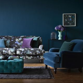 living room with navy blue wall and sofa flower pot