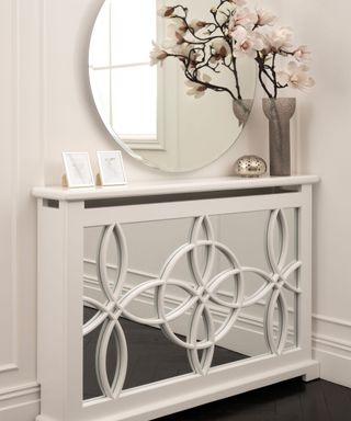 mirrored radiator cover in hallway with circular mirror