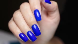 Hand with cobalt blue nails