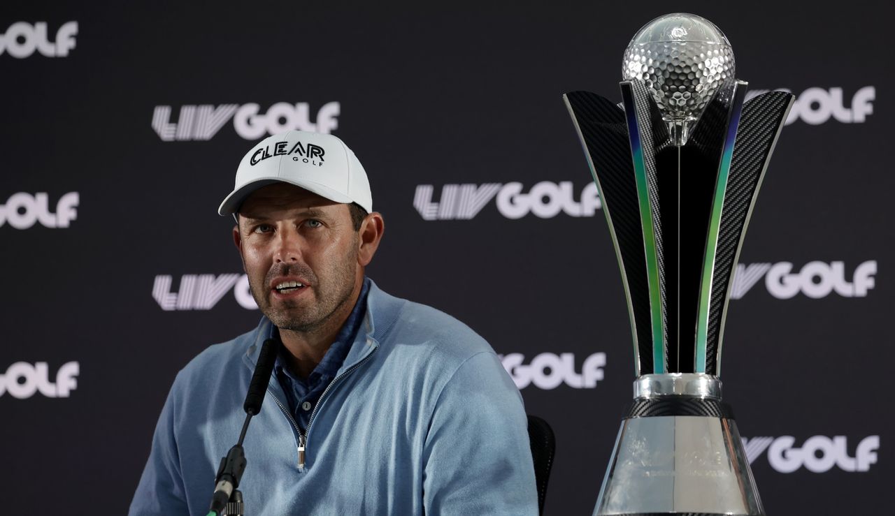 Schwartzel speaks to media with his trophy beside him