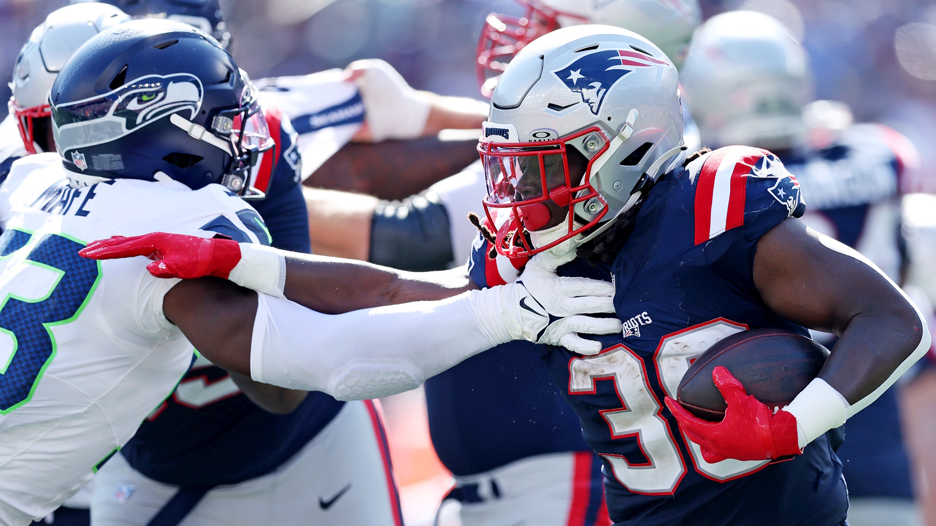 Players of the Seattle Seahawks and New England Patriots battle things out.