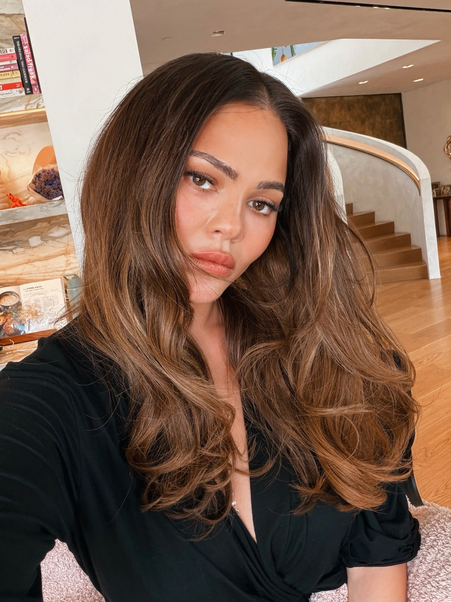 Chrissy Teigen with brown hair with blonde highlights