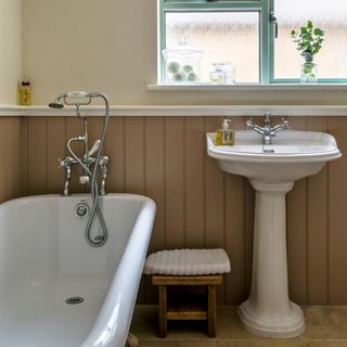 bathroom cream wall with bathtub and basin