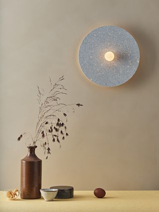 Wall light next to pottery pieces