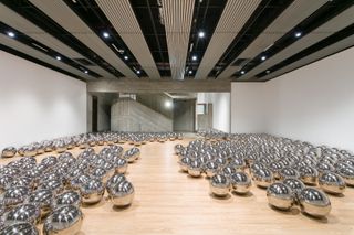 Interior with numerous round, silver, reflective sculptures