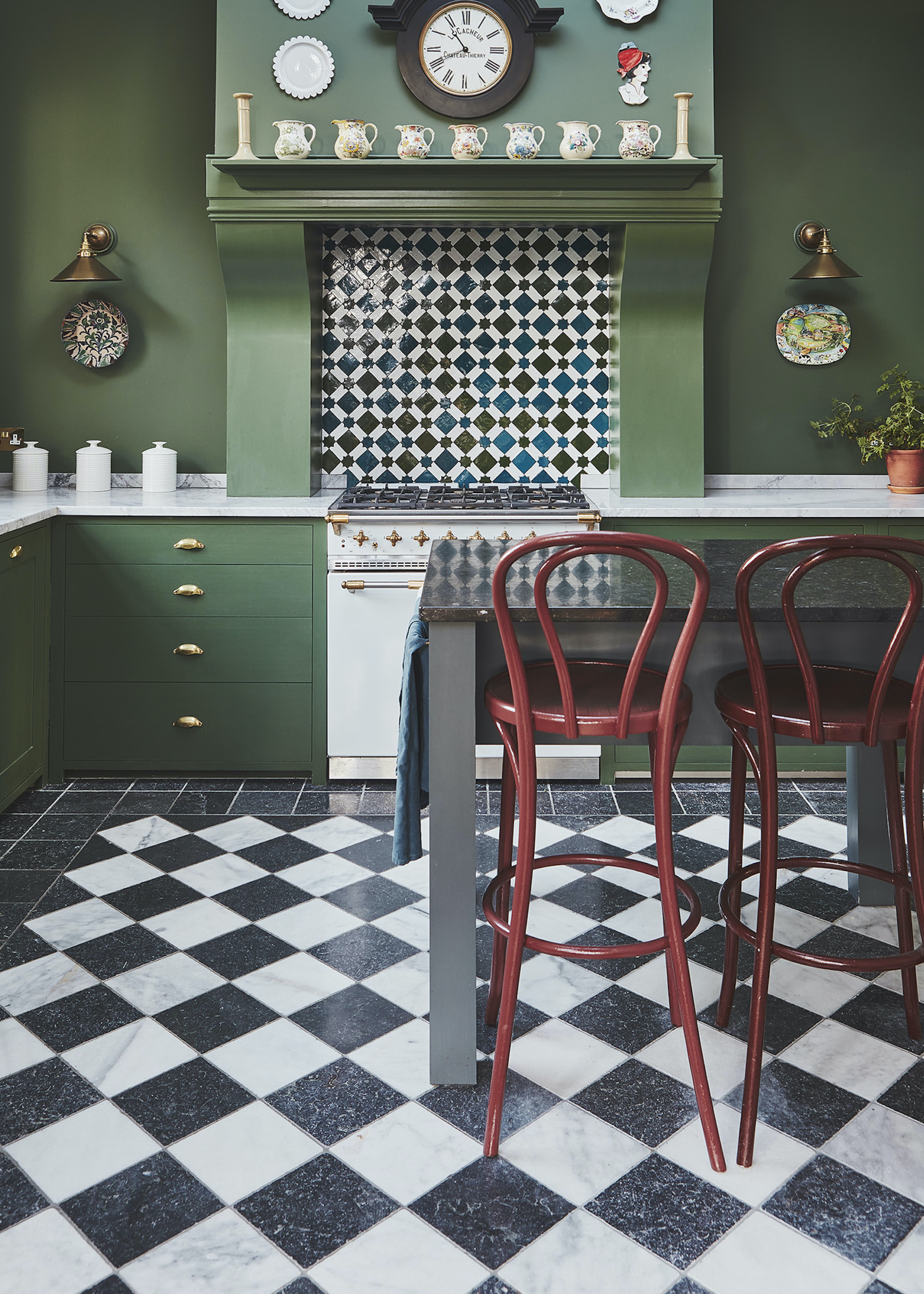 green kitchen with black and white checkered tiles