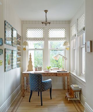 Home office with white walls and pretty fabric blind