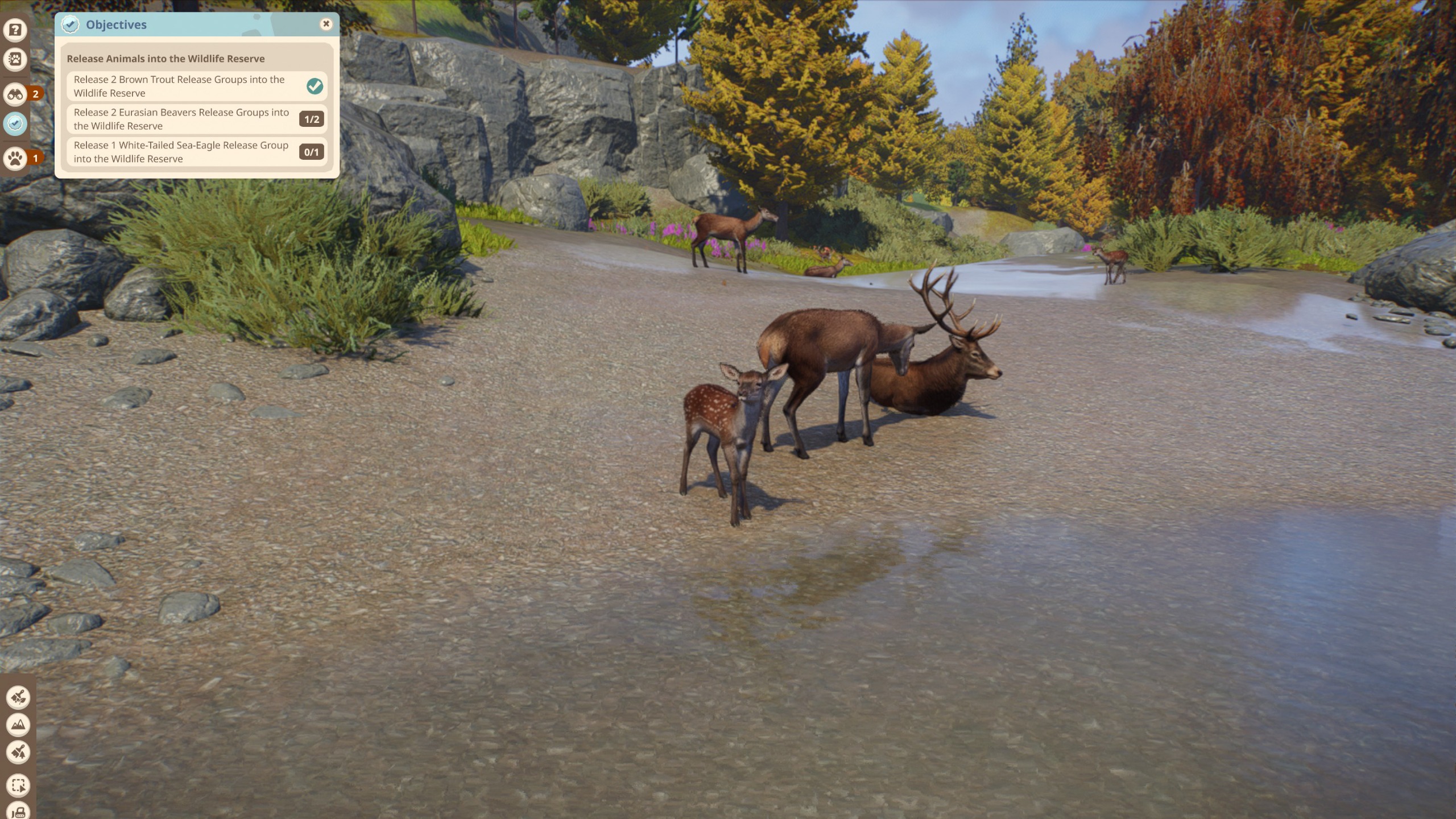 Red deer sit by a water source in a wildlife preserve in Planet Zoo 2.