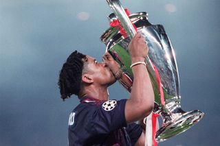 Frank Rijkaard kisses the Champions League trophy after Ajax's win over AC Milan in the final in 1995.
